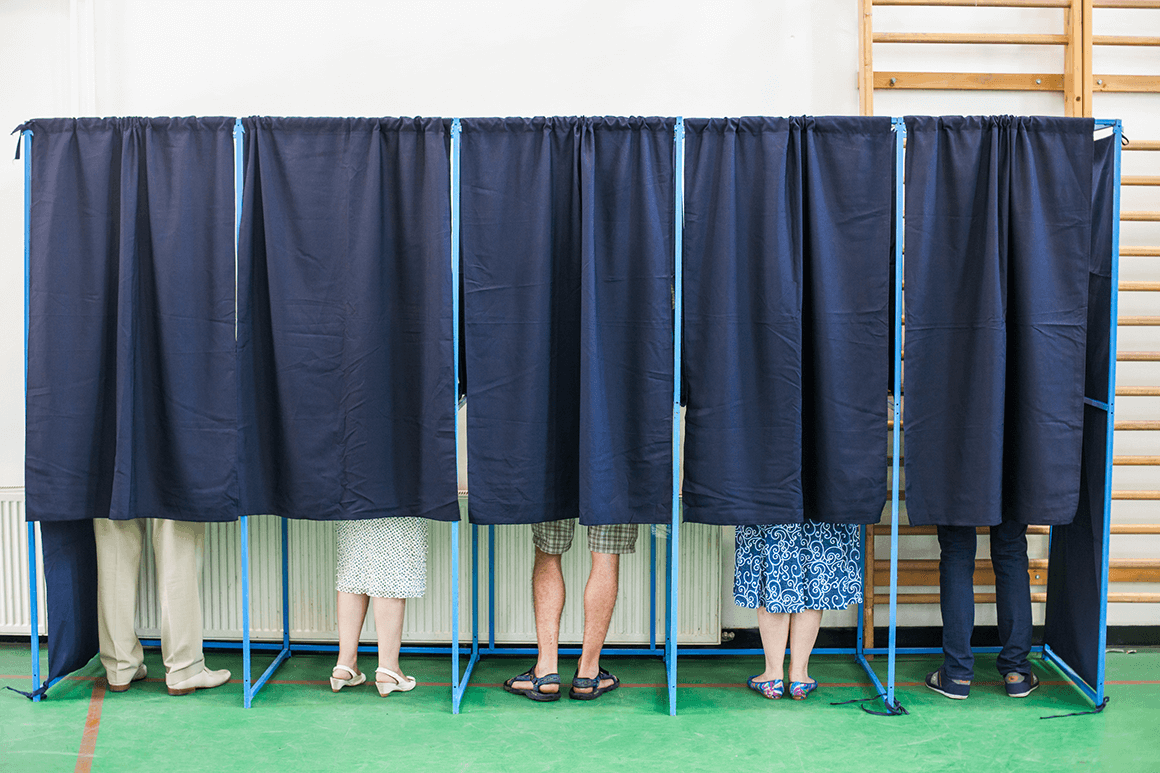 Five voting booths filled with voters who were informed about the voting location through political campaign SMS messages