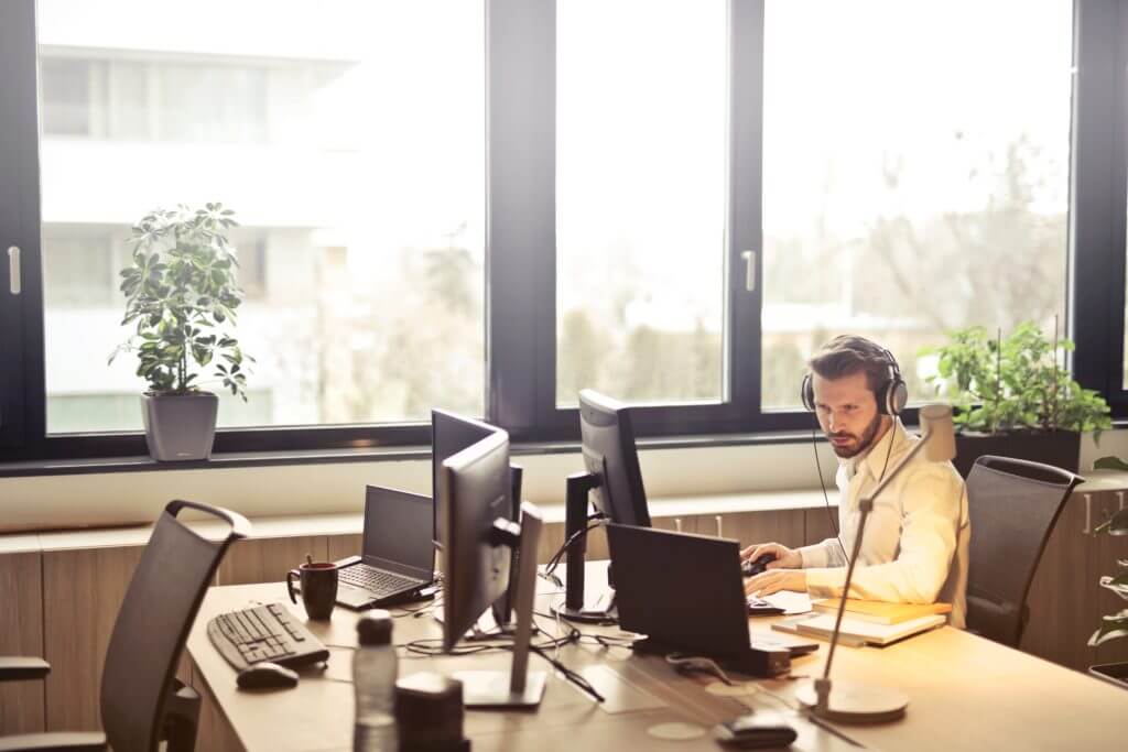 Customer Support agent with head phones and computer