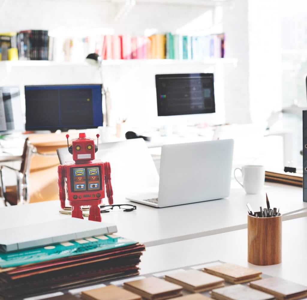 Desk with computer and toy robot