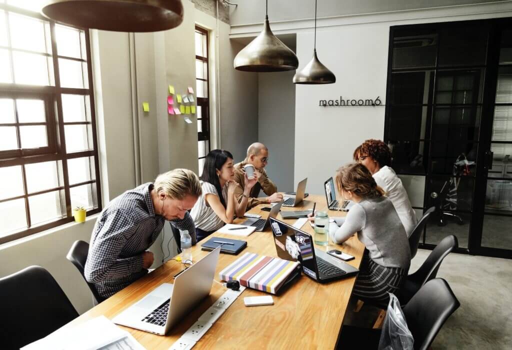 Team working with computers around table