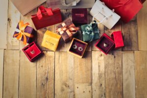 Floor half-covered with present boxes wrapped in red, purple, and yellow wrapping paper