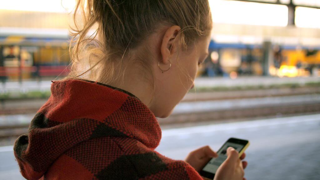 Woman texting, meant to symbolize business texting statistics