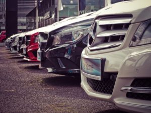 Close-up of a line of cars at a car dealership