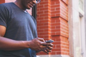 Man texting on phone.