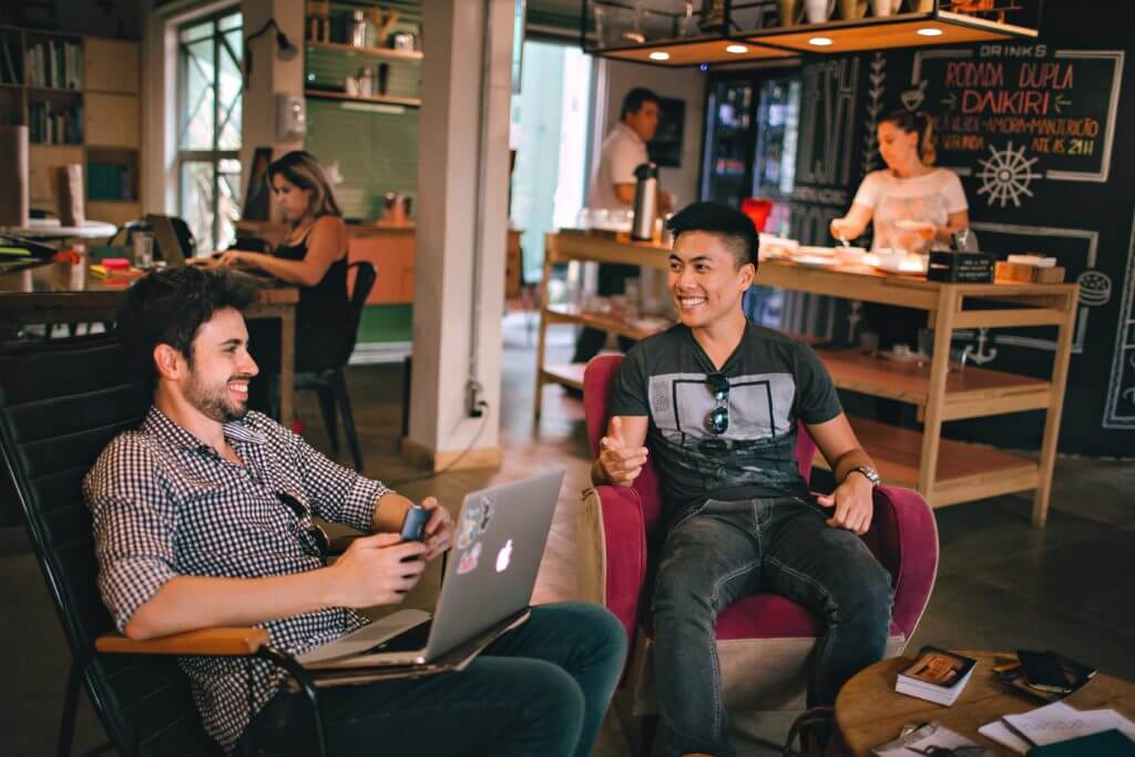 Men working and brainstorming in a lounge.