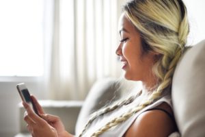 Woman chatting and checking phone.