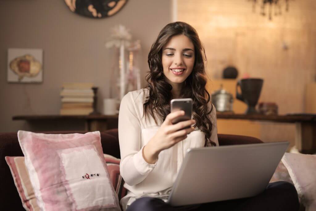 Businesswoman with phone and texting.