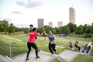 Camp Gladiator trainer motivating a member.