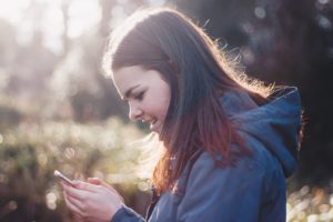 Woman texting from mobile phone.