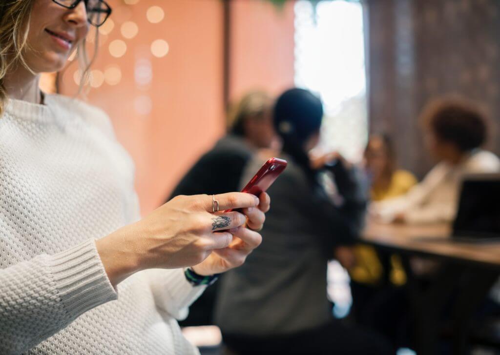 Woman looking at phone and typing.