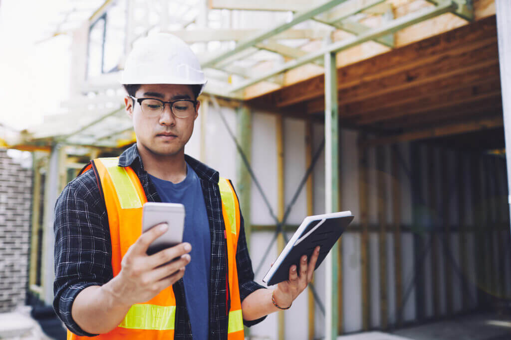 Construction worker holding phone