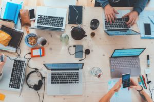 Multiple agents at desk, working. 