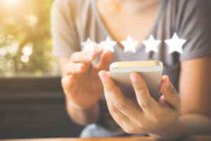 Person writing SMS review on phone