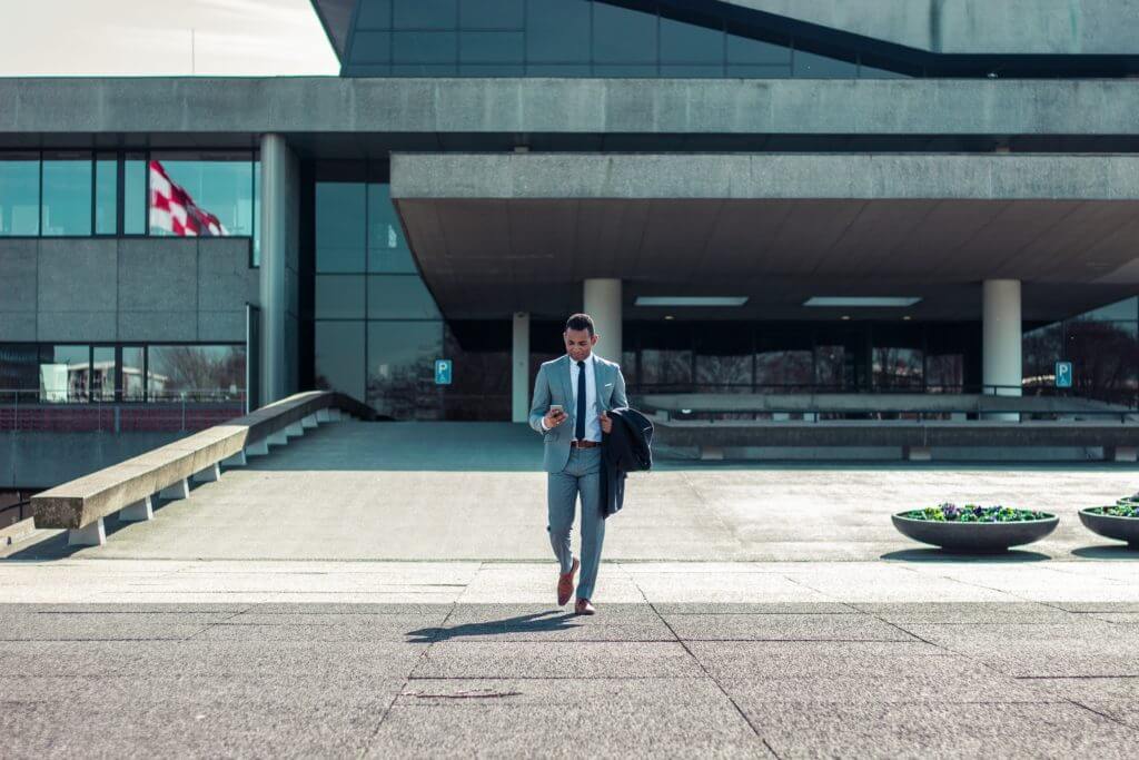 Lawyer walking and texting