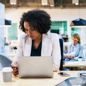 Person working at desk with computer.