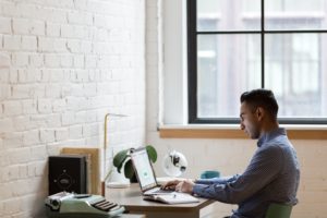 Business person working on computer at desk.