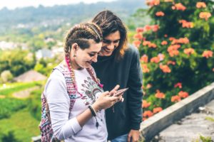 Two women checking phone.