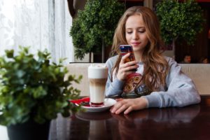 Woman reading phone.