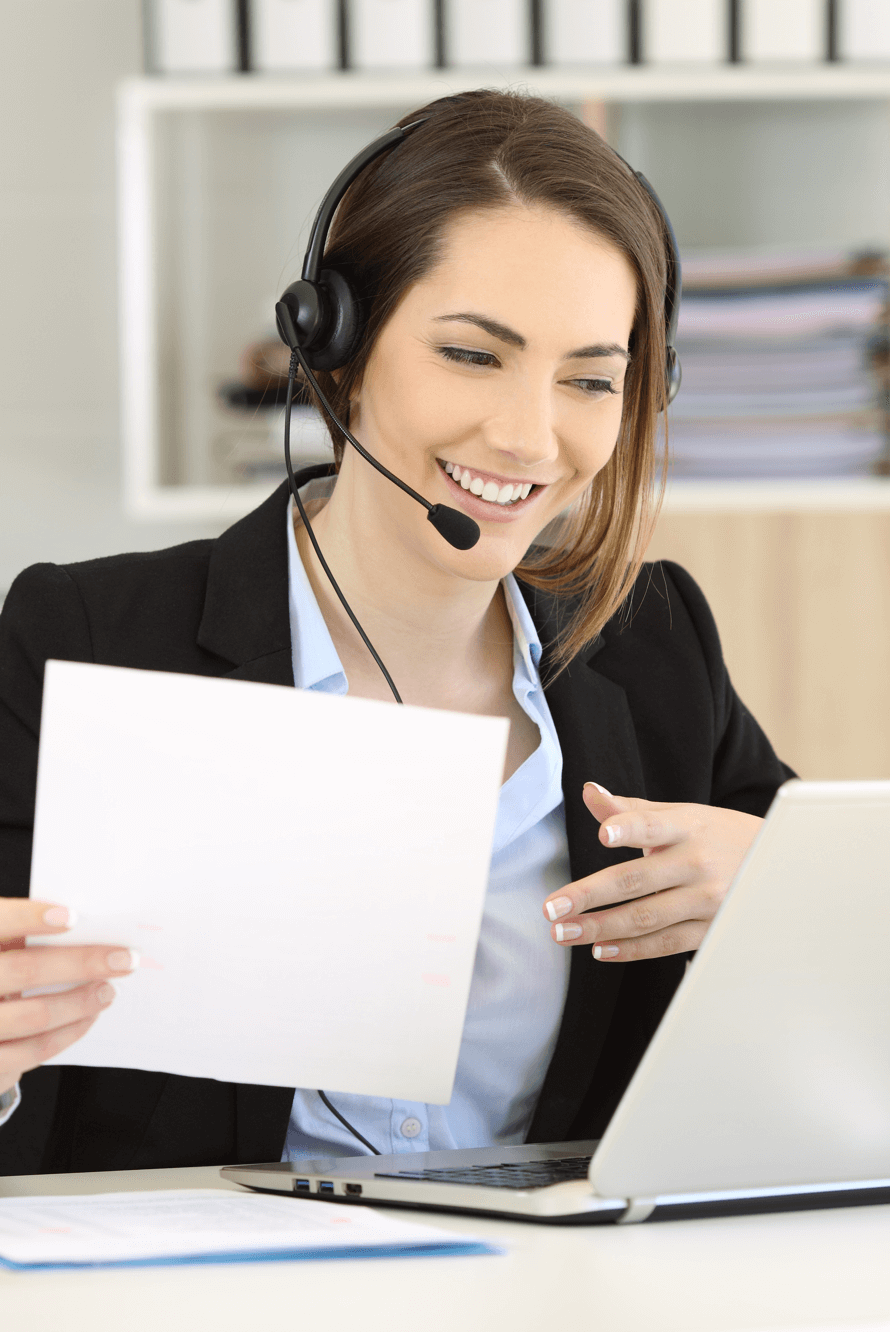 Agent smiling while talking on phone and reviewing customer's business texting history on her laptop