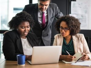 Employees in front of a laptop.