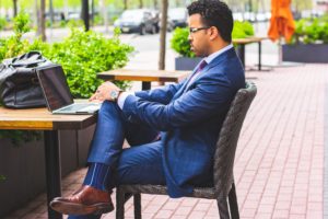 Business person with laptop at table.