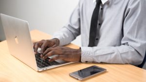 Business person working on laptop at desk.