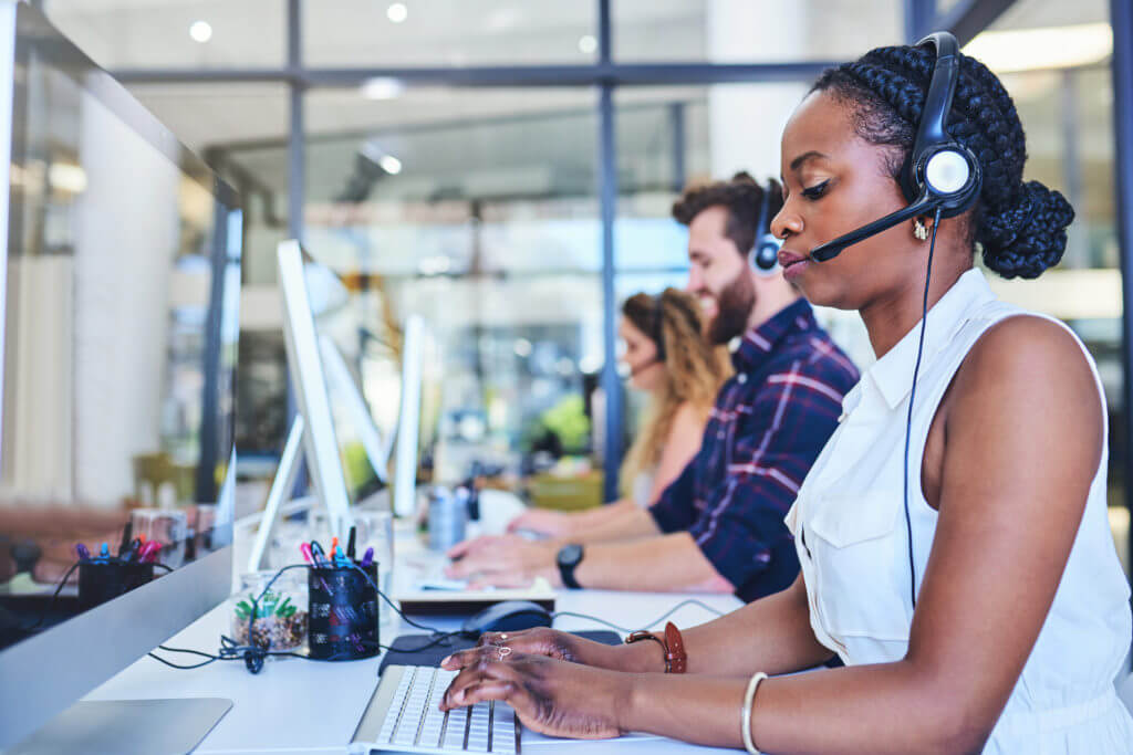 Person in call center texting from computer.