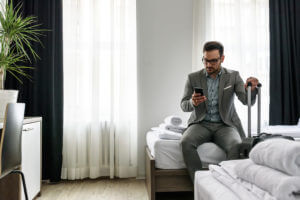 Hotel guest in room, using phone.