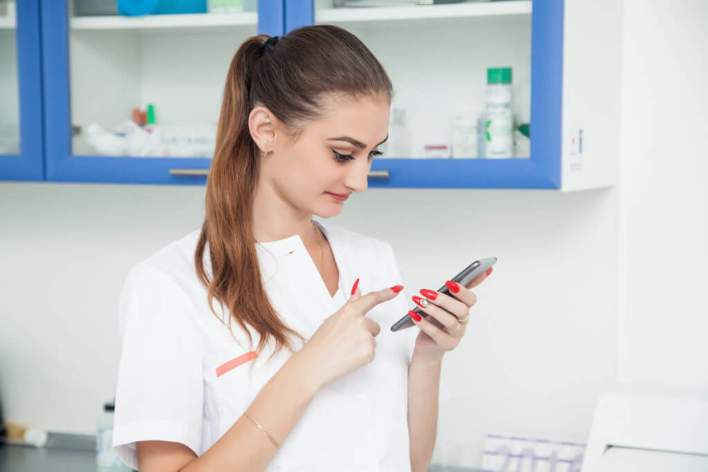 Dentist texting on phone