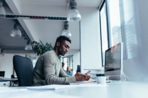 Person working at desk with phone