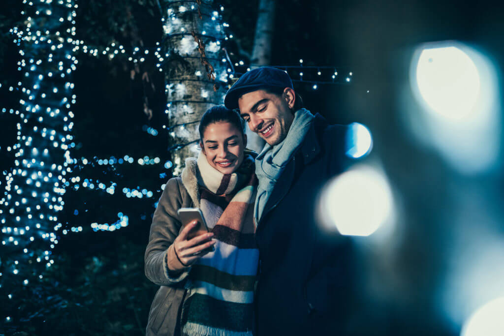 Customers using phone outside during holidays.