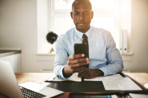 Lawyer using business text messaging at his desk