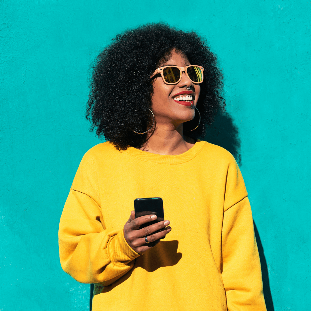 Woman smiles and looks into the distance after she reads a helpful retail SMS marketing message
