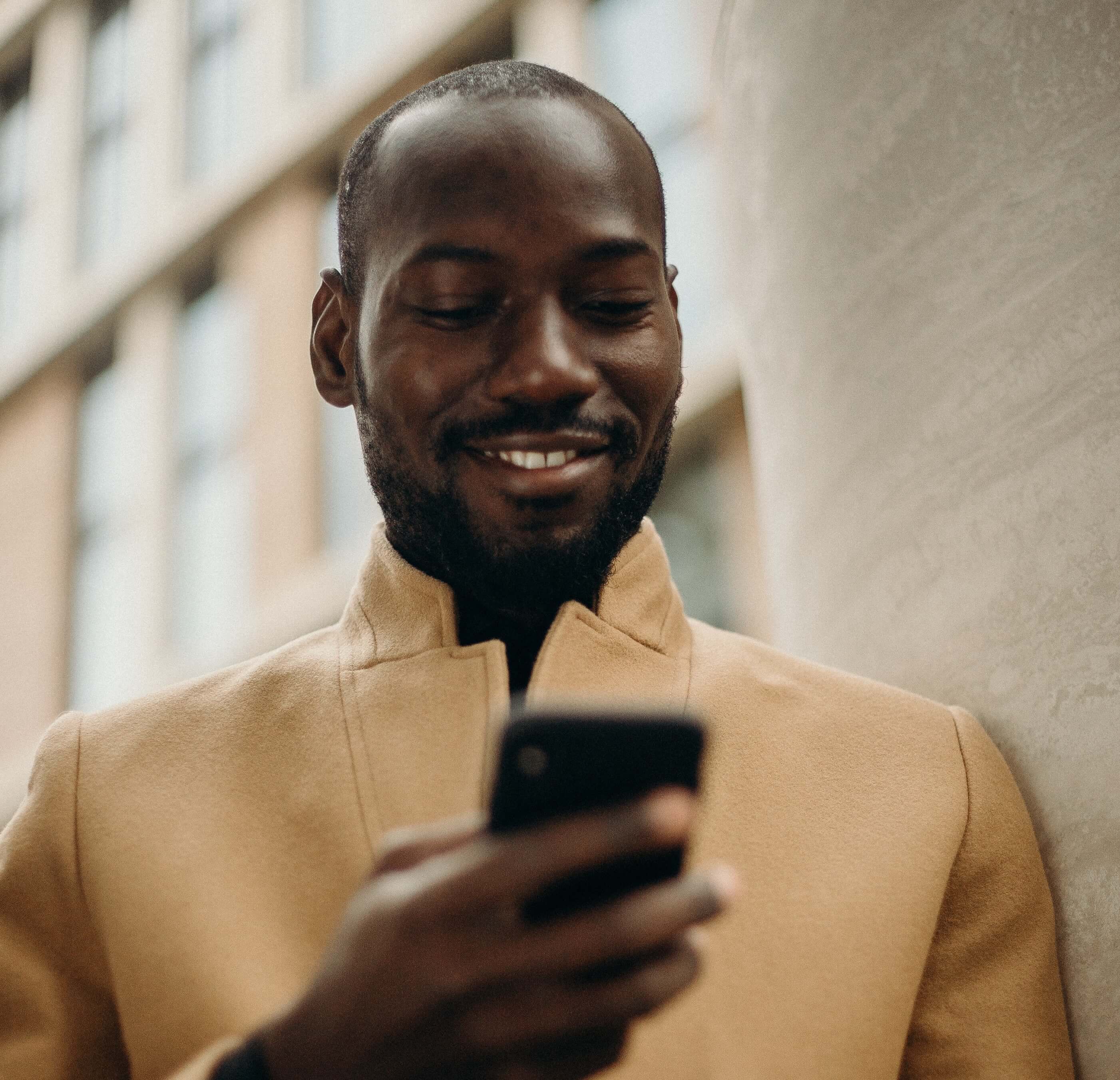 Man smiling and using omnichannel messaging