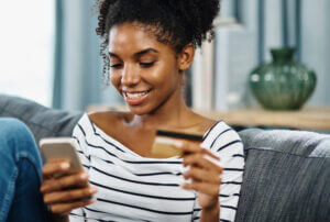 Young woman shopping with phone at an eCommerce business