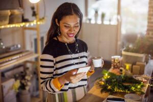 Woman reading text from holiday SMS templates