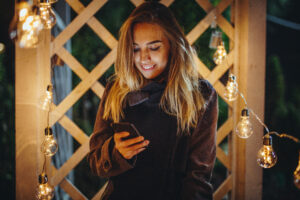 Woman Reading SMS New Year's Greetings