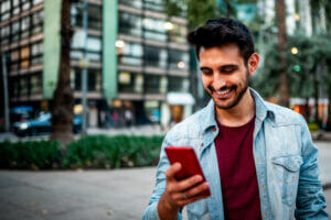 Man using business text messaging on a sidewalk