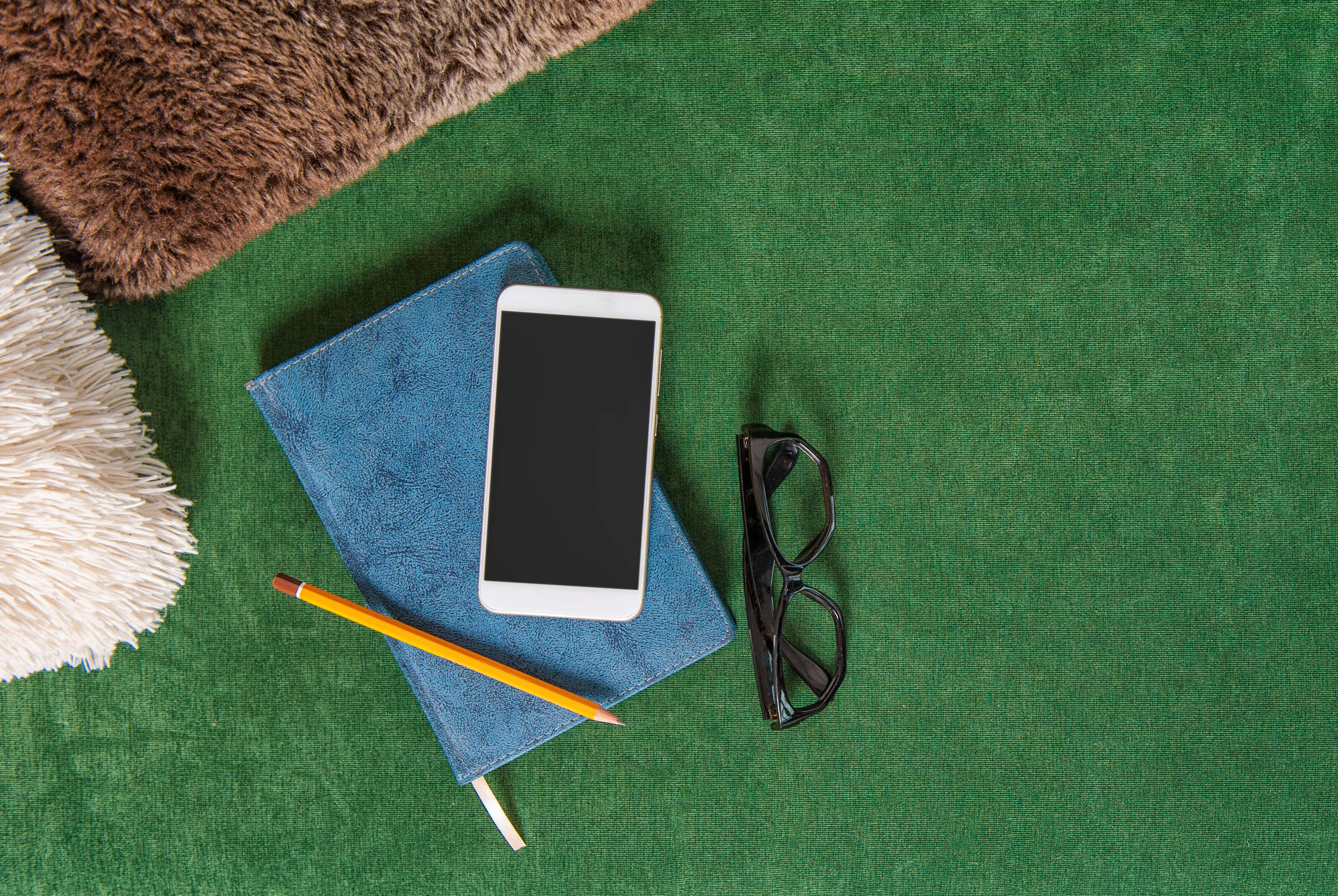 Top view of notebook and phone on top