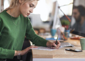 Young Woman Mapping Out Business Text Messaging Workflows