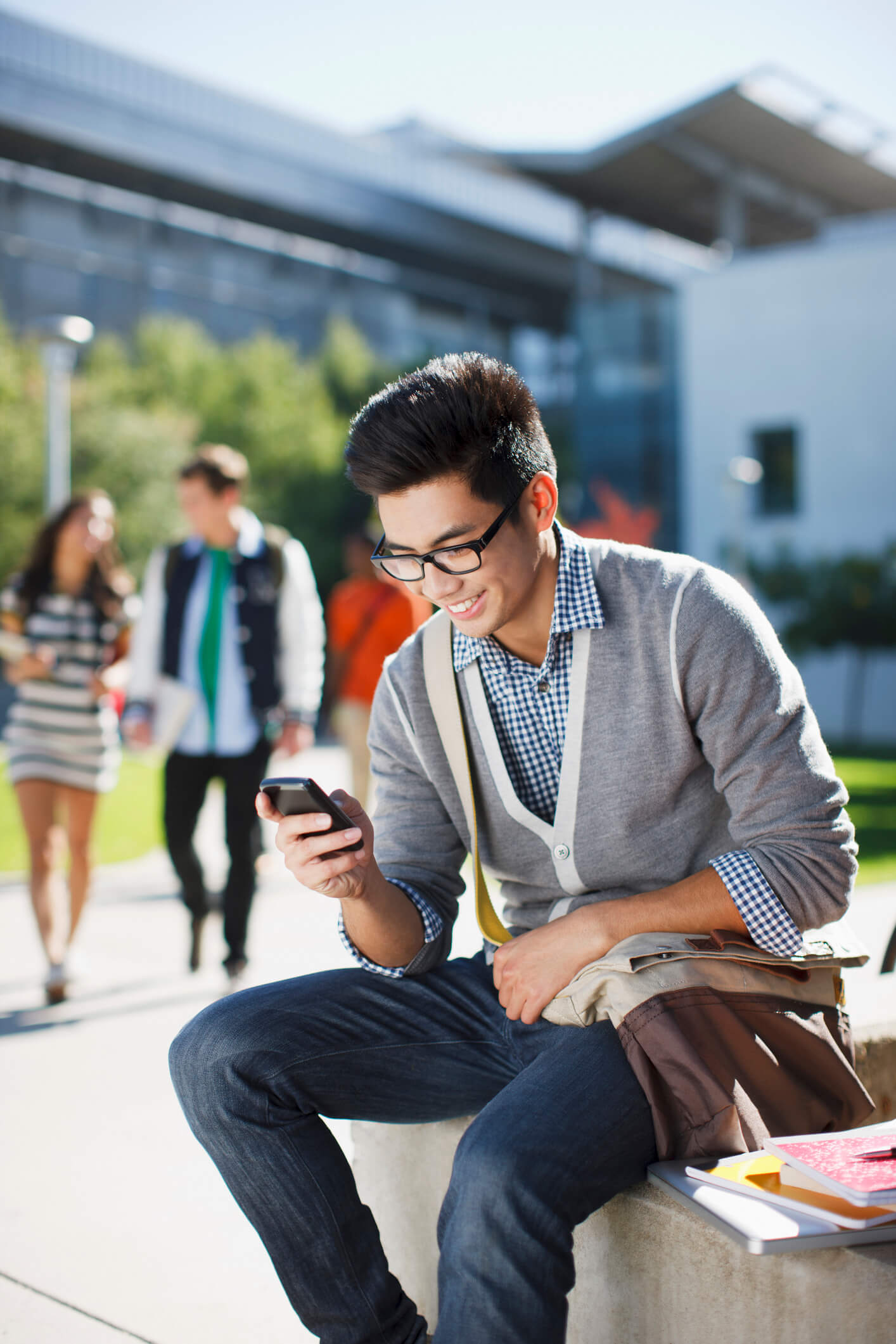 Student using college SMS in the quad