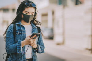 Young woman reads business SMS content during COVID-19