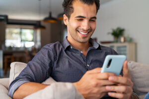 Man smiling at SMS Customer Engagement content