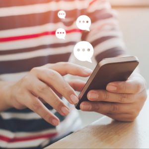 Hands texting using conversational customer engagement