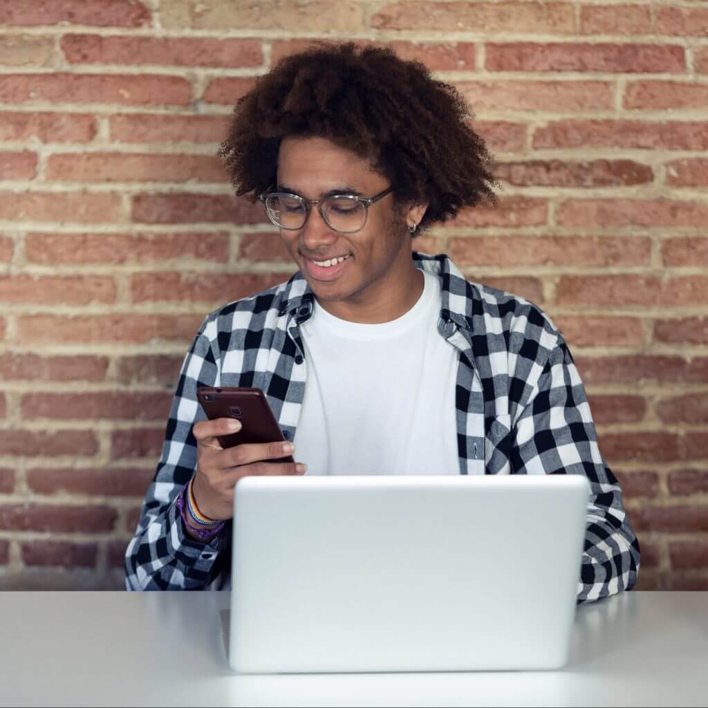 Man on cellphone using conversational customer engagement to answer business texts.