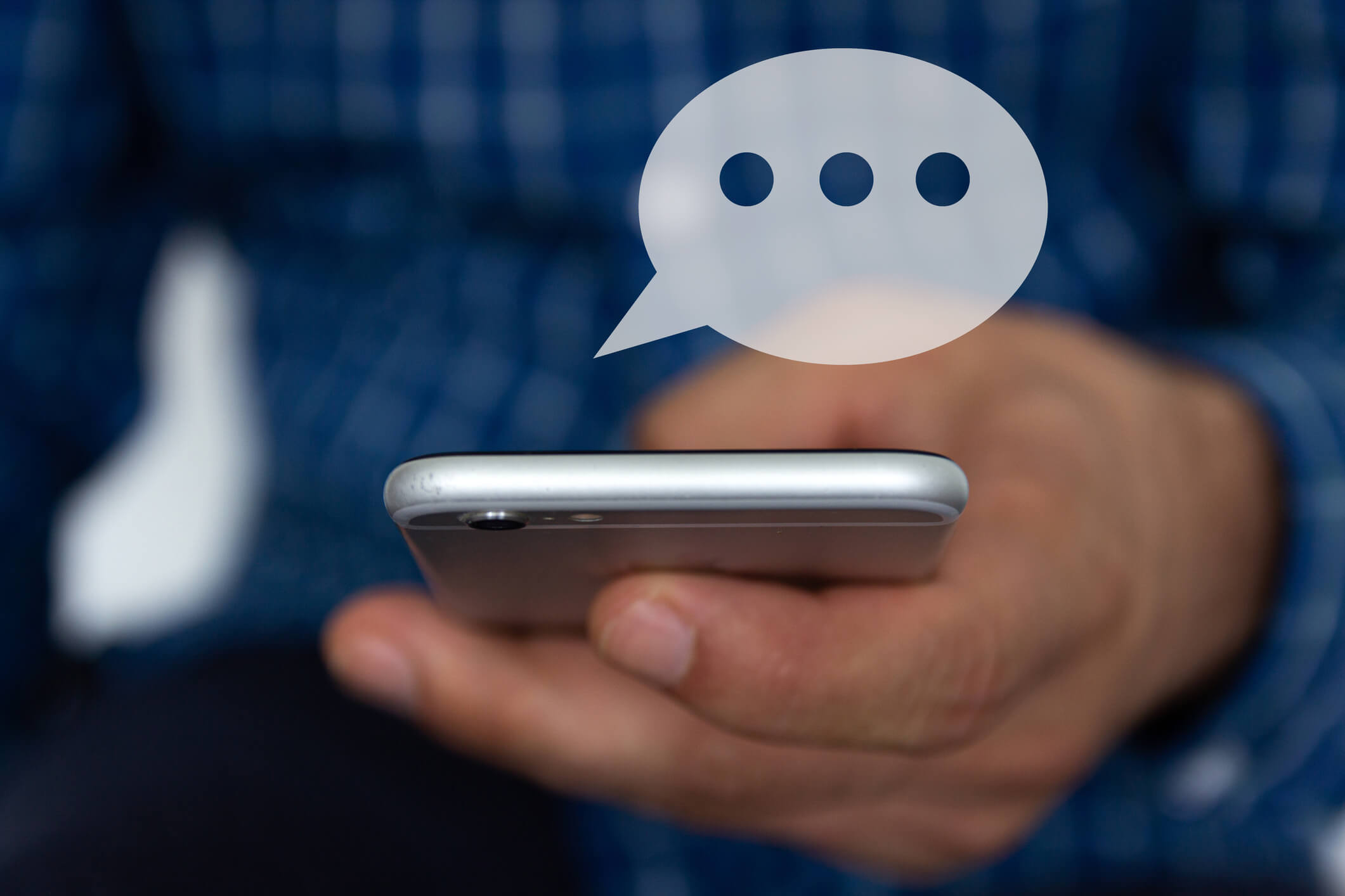 Hand of man typing text on smartphone, using SMS insurance