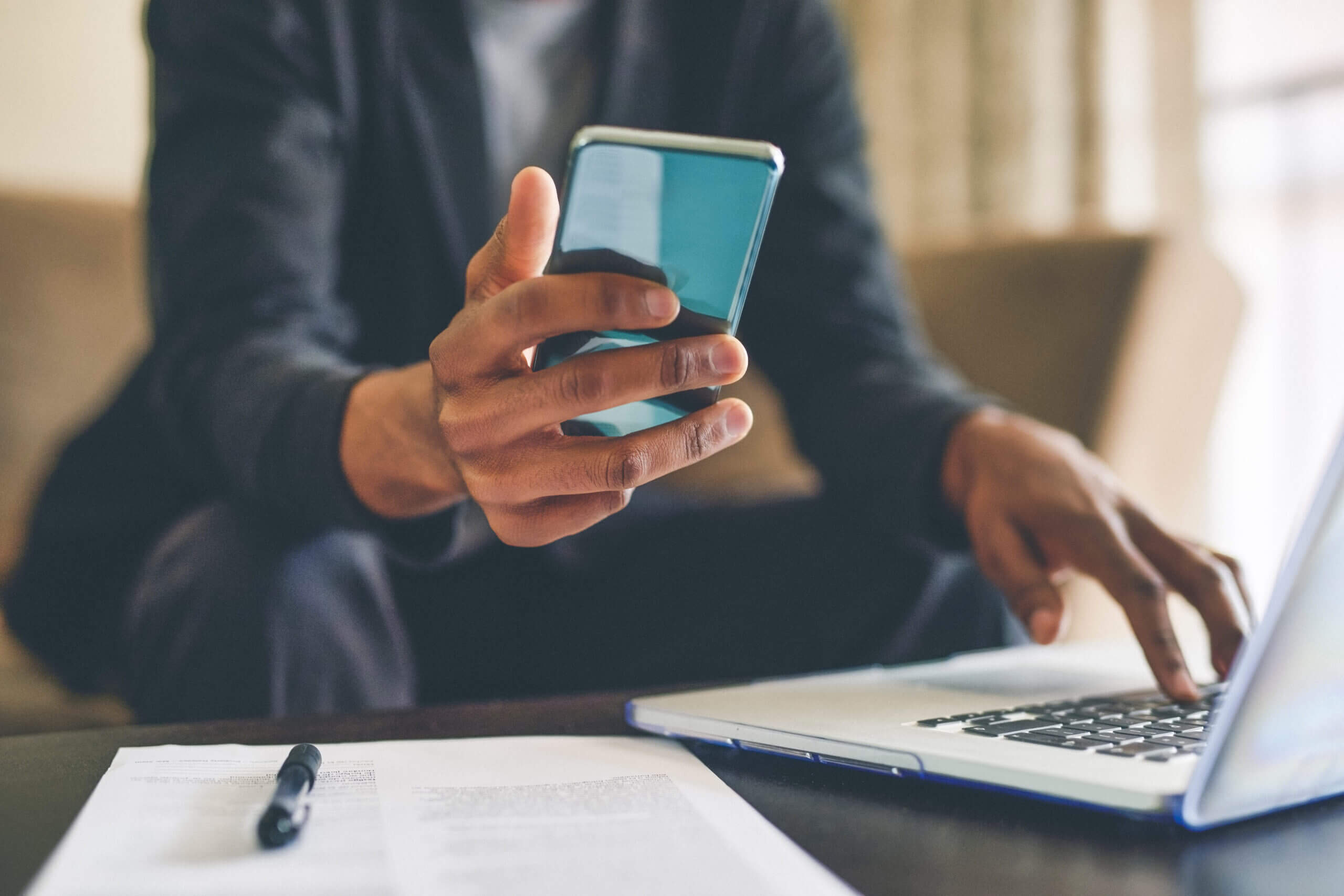 Woman's hands texting next to laptop and using successful Conversational Customer Engagement