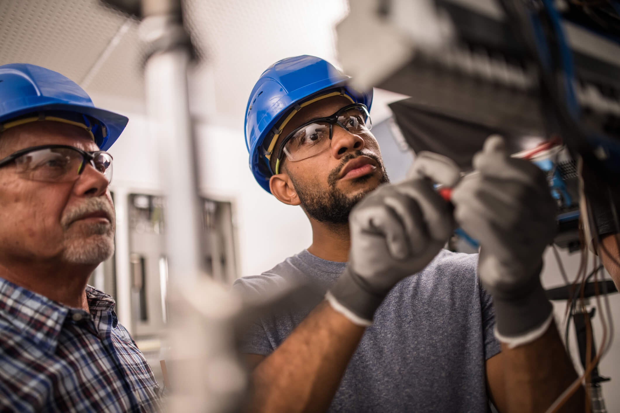 Electricians working on a fuse box