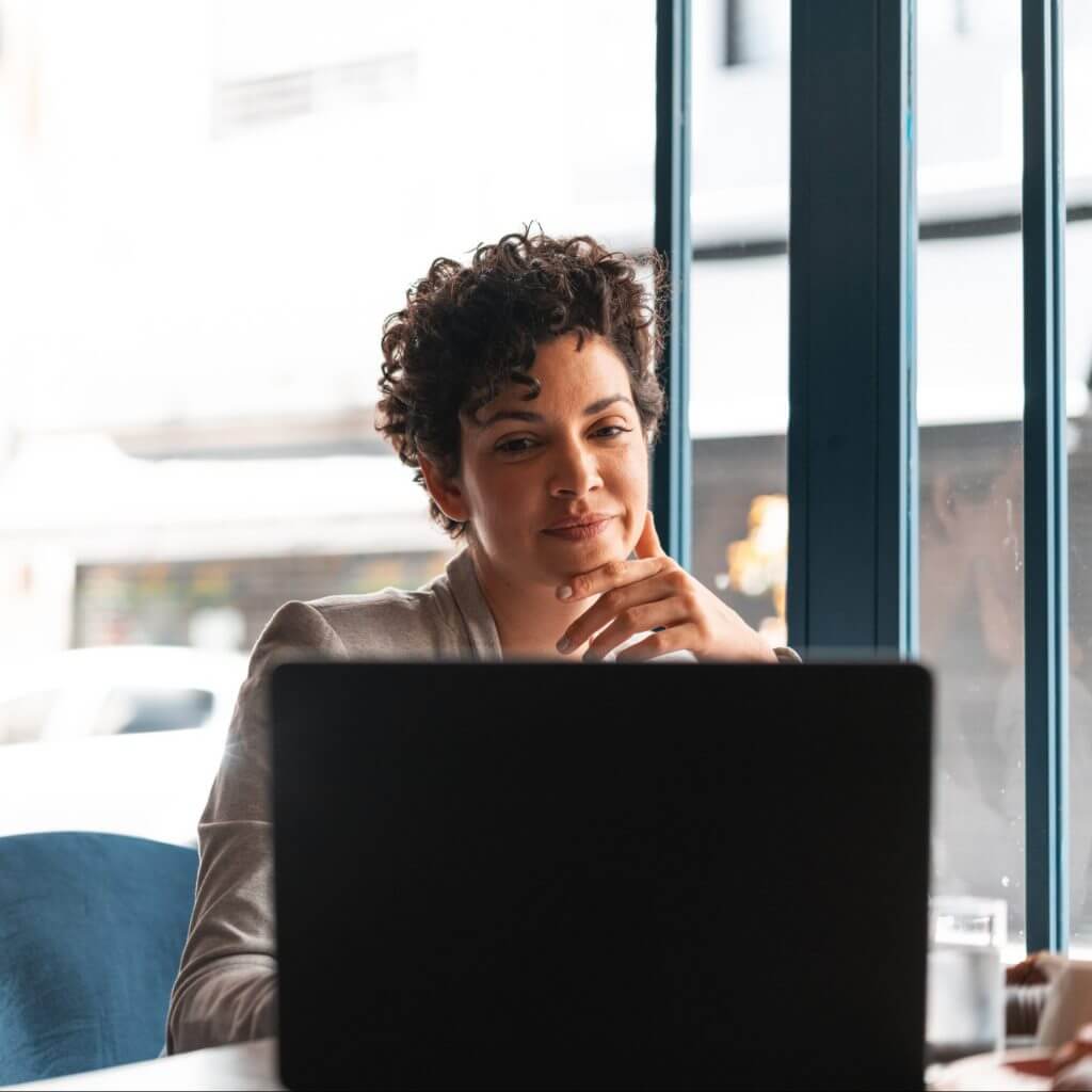 Woman at desk creating a business text messaging brand voice guide