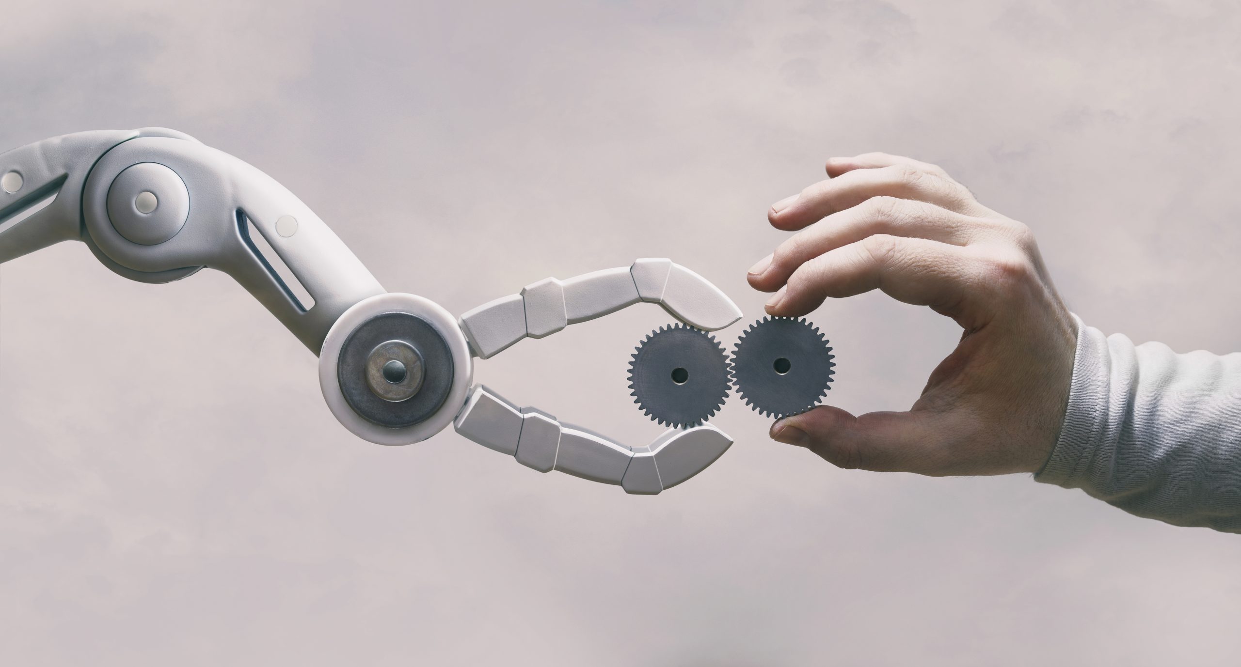 Robot and human hands signifying automated replies